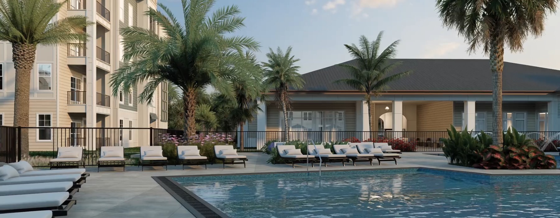 a pool surrounded by lounge chairs with trees and a large building in the background