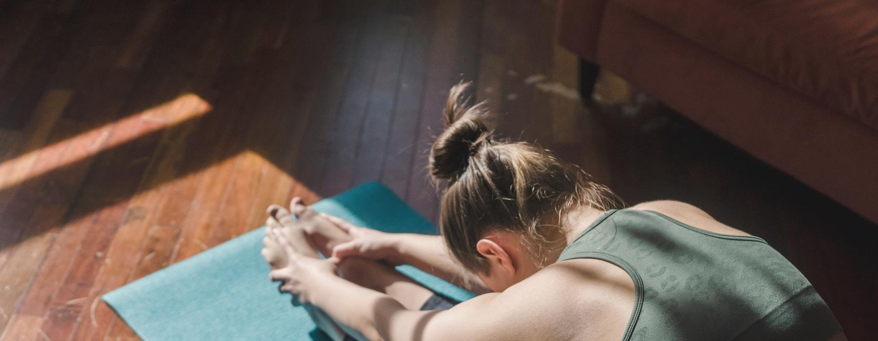 a person lying on a yoga mat