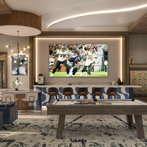 a room with a large screen pool table and chairs